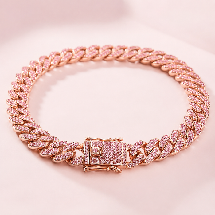 Rose gold chain bracelet with pink gemstones on a pink background